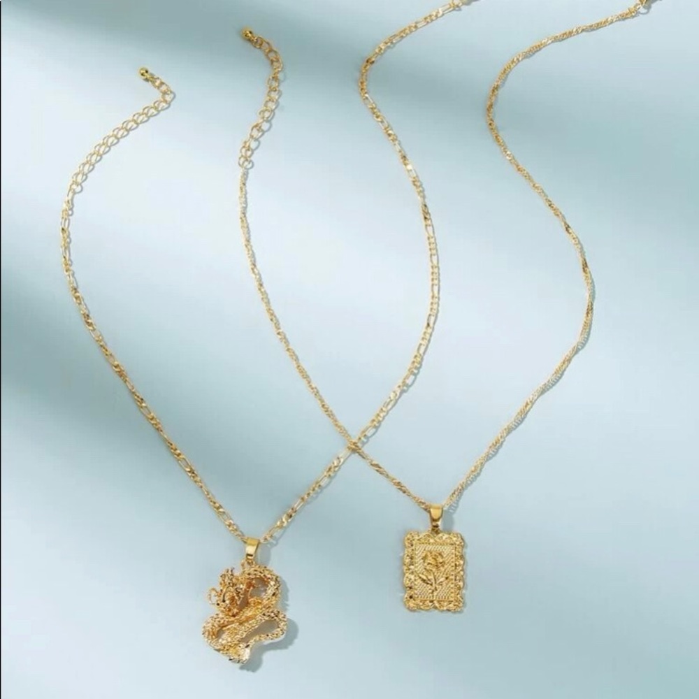 This is a dragon and rose frame necklace set
